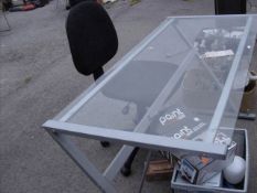 An office table glass top and chair