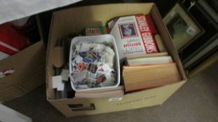 A box of loose stamps and stamp books