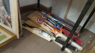 A quantity of cricket bats and hockey sticks