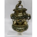 An 19th century Oriental brass sensor on stand surmounted dog and with lion head handles