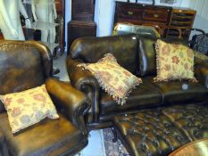 A brown leather 3 piece suite with 2 foot stools