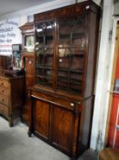 A Victorian mahogany veneered glazed top bookcase and cupboard base