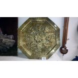 An Indian brass engraved and embossed octagnal wall plaque