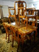 An Edwardian figured walnut dining table with 1 leaf on Queen Anne legs with 6 matching chairs