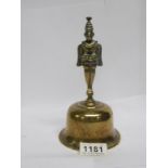 A 19th century Oriental brass bell surmounted two faced figure