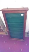 A mahogany wall display cabinet