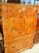 An inlaid yew wood cabinet with lift up top