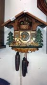 A cuckoo clock with 3 weights
