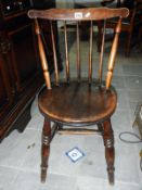 An oak spindle back side chair with turned legs & circular seat