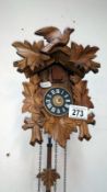 A small cuckoo clock with weights
