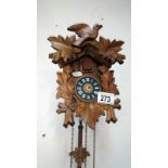 A small cuckoo clock with weights