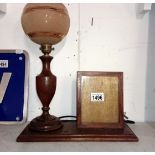 A 1930's oak table lamp with integral photo frame