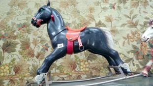 A black plastic rocking horse