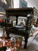 An old carved oak two tier table