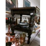 An old carved oak two tier table