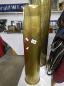 A large brass shell case,