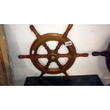 A brass bound light mahogany ships wheel marked V.M.