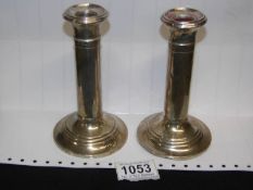 A pair of hall marked silver candlesticks