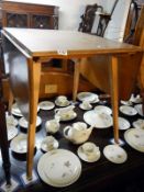 An Ercol light wood dropleaf table