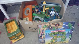 A collection of Teenage Mutant Ninja Turtles, figures, building etc.