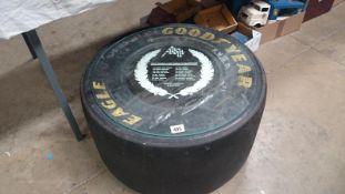 A 1993 Formula 1 used racing tyre with etched glass top,