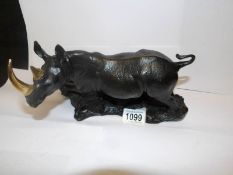 A bronze figure of a Rhino with gilded horns