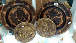 2 wooden chargers with floral decoration and 2 others