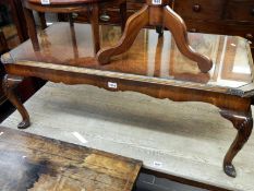 Edwardian glass top coffee table with Queen Anne legs and a walnut veneered top