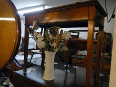 A mahogany fold over card table on tapered legs