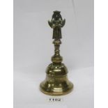 A 19th century Oriental brass bell surmounted two faced Diety figure,