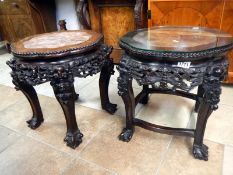 A pair of oriental hardwood ebonized pot stand with marble inserts one with a glass panel on top