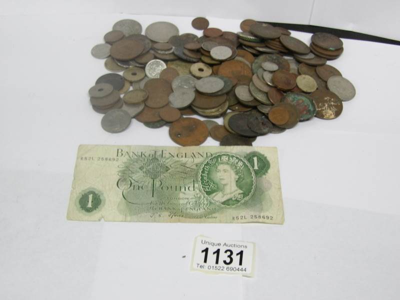 A collection of coins including pre 1947 silver and a green £1 note