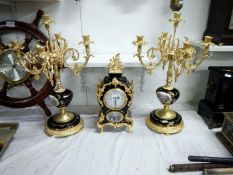 A French style 3 piece clock garniture featuring 2 candlesticks