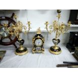 A French style 3 piece clock garniture featuring 2 candlesticks