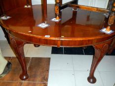 A mahogany extending dining table on chunky Queen Anne legs with 1 leaf