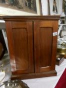 A small 19th century mahogany shelved cabinet