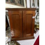 A small 19th century mahogany shelved cabinet