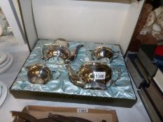 A boxed 4 piece silver plate tea set