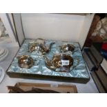 A boxed 4 piece silver plate tea set