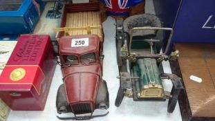 A vintage style tinplate vintage car and American lorry