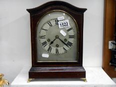A curved top late Victorian mantel clock