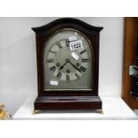 A curved top late Victorian mantel clock