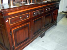 A large dark oak sideboard with 4 drawers & 4 cupboards