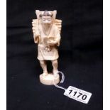 An antique ivory figure of a man with book 5.