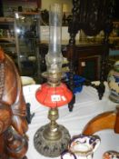 Oil lamp with red glass vessel