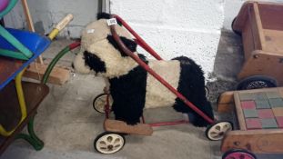 A childrens vintage push along/walker panda