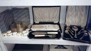 A mixed lot of silver plate including place mats, napkin rings & cased cutlery etc.