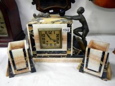 A French art deco mantle clock set with mounted spelter figures and dog