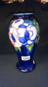 Moorcroft floral vase with blue background (crazing to flowers)