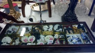 A display case and a collection of miniatures